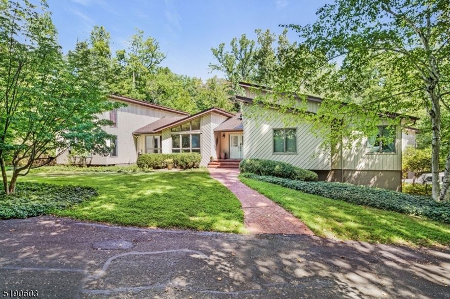 Nature abounds in this gorgeous contemporary ranch which sits on a private flag lot. This custom home offers an abundance of privacy...your own peaceful oasis...yet it is located on a cul-de-sac street in a conveniently located neighborhood which is close to shopping, schools and restaurants. Built for entertaining as well as relaxation, upon entering the home you notice the expansive open floor plan, including a modern kitchen with custom cabinetry, vaulted ceilings and a skylight. The primary BR includes a WIC, a spacious adjoining leisure room, and a spectacular bath area with a jetted tub, 2 separate sink areas, and a huge shower w/two distinctive separate shower heads. A private wing with a separate entrance boasts a nicely sized BR, a full bath and a den with a loft as well as a soothing spa room..complete with an indoor hot tub, sauna, dressing room and large windows allowing views of the serene outdoors. The finished basement features custom wood wainscotting throughout, a recreaction room, a media room, and an exercise room. The expansive private wooded backyard complete with a babbling stream includes a large concrete inground pool with built in spa, a separate gazebo for dining to the side of the pool area, a paver patio with a custom fire pit as well as an expansive upper deck area overlooking the backyard. This unique property must be seen to appreciate the unique floor plan and custom features. Best of all... this property can be yours!