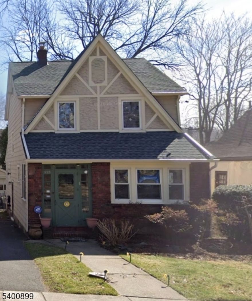 Charming 2-bedroom, 2-bath Tudor Colonial offering a perfect blend of classic charm and versatile living space. Enjoy a fully finished basement and a cozy attic with bamboo flooring ideal for a home office, studio, or guest retreat. The home fills with natural afternoon light, creating a warm and inviting atmosphere, especially through the multiple stained glass windows.  The main living areas feature beautifully preserved hardwood flooring and the eat-in kitchen boasts stainless steel appliances with a serene view of a lush, private backyard. Additional highlights include a newer roof, a long driveway for ample parking, and an attic skylight.  Ideally located near major highways, restaurants, shopping, the bus stop to NYC and within a 10 minute walk to multiple houses of worship, a rare and highly desirable convenience. A wonderful opportunity for buyers to add personal touches and build value.