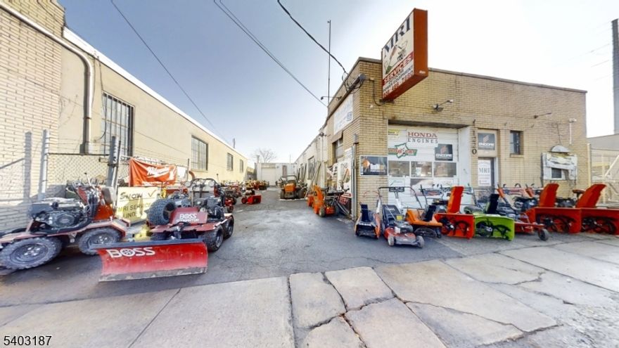 This commercial building at 1220 E. Elizabeth Ave, Linden, NJ (Tenant Occupied: Biz Not Included)  features two separate units totaling approximately 3,500+ square feet of versatile space and is not located in a flood zone. The front unit, approximately 1,900 square feet, is configured as a retail store with a large attached storage garage and includes an open garage area of about 1,240 square feet, a 612-square-foot retail area, a dedicated office, high ceilings, one 10-foot-tall garage door, and one bathroom, with multiple access points that support efficient workflow. The rear unit, approximately 1,660 square feet and originally used as an auto body shop, offers a spacious main workspace measuring approximately 50' x 33'9", a paint bay room of approximately 22'3" x 13'1", high ceilings, one garage door, and one bathroom, along with multiple entrances for convenient access. The building features solid construction with a large structural metal support beam and sits on a 60' x 120' lot, allowing the units to operate independently or together. This property is well suited for contractors, automotive-related businesses, retail with service operations, storage, warehousing, distribution, or light industrial uses in a convenient Linden location. Building Class: CB-1S   Tax Zone: R-2B   Property Class: 4A   Built in 1957.