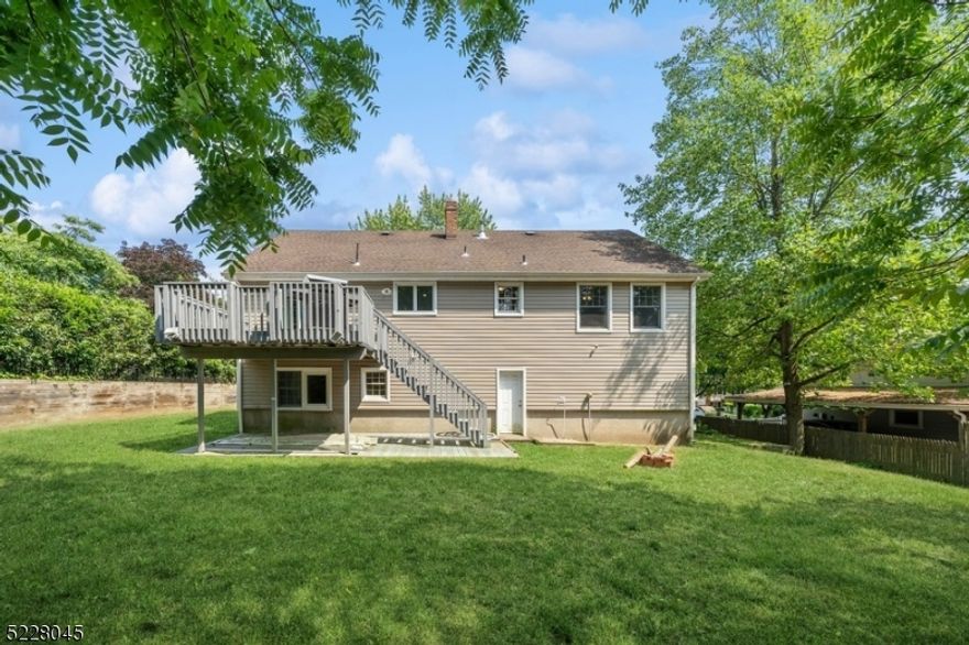 LOCATION, LOCATION!!!  Spacious, renovated, and maintained home with four bedrooms and two bathrooms is looking for new owners! First floor features large living room; beautiful kitchen opening to the dining room offering white cabinets, granite counter tops, peninsula with wine refrigerator, stainless steel appliances; dining room with doors to a large deck, three bedrooms and the main bathroom.  You will be impressed by high ceilings in living and dining rooms, hardwood floors on the first level.  Master bedroom suite with huge walk-in closet, amazing bathroom is located on the ground level.  Two car garage, leveled private backyard, super convenient, excellent, yet quite location adds to the picture of awesomeness! Come and see for yourself!!