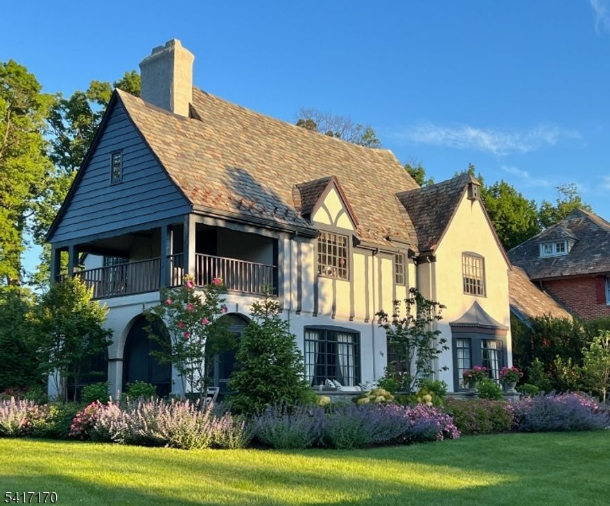 Perfectly positioned on a corner lot on premier Douglas Rd, this 5 BR, 3.1 bath home blends classic charm with magazine-worthy renovations and exceptional indoor/outdoor living. The stunning renovated kitchen features high-end cabinetry, a large center island, marble backsplash and countertops, and a separate seating area framed by an oversized window that fills the space with natural light. Luxuriously renovated baths showcase beautiful finishes and thoughtful design throughout. The spacious living room is ideal for entertaining and offers access to the sunroom with bluestone floor. Bedrooms are well-scaled and light-filled, including a show-stopping primary suite with a custom walk-in closet with abundant shelving and storage, and a beautifully appointed bath with double custom quartz vanity, large porcelain shower and marble floors. Enjoy multiple inviting spaces to relax and unwind, including the welcoming front porch, second-floor balcony, and the private gravel patio tucked behind the garage that feels like a secret garden. The attached garage connects to the home via a convenient breezeway perfect for bringing in groceries on rainy days. A finished basement and central air are added conveniences. Professionally landscaped grounds w/exterior accent lighting enhance the curb appeal. Just 2 blocks from highly regarded Glen Ridge public schools, a nearby park, and NYC transportation from GR train station, this special home offers both beauty and unbeatable convenience.