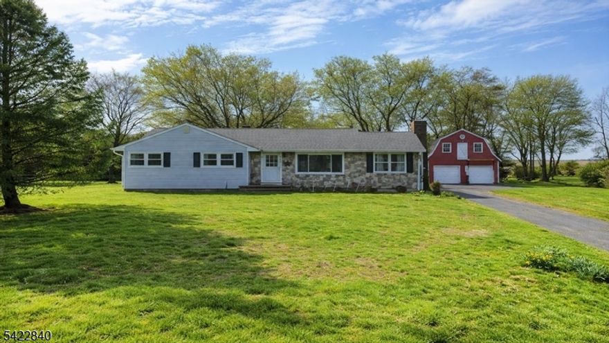 Set on nearly 1.5 acres, arrive to a setting where open skies, surrounding estates, and a sense of calm create an immediate shift from the everyday. This 4 bedroom, 2 bath residence offers a rare balance of space, privacy, and possibility, with an easy, natural layout designed for both comfort and flexibility while presenting a unique opportunity to shape a home that reflects your personal vision. Natural light moves effortlessly throughout the main living areas, creating an energy that feels both open and grounded, while the layout provides separation without sacrificing flow, allowing each space to function with purpose. A relaxed gathering area centers around the home's fireplace, offering a warm and inviting setting for everyday living. The kitchen remains central to the home, ready to be reimagined into something truly tailored to your lifestyle. Each bedroom offers generous proportions, creating a strong foundation for private retreats. A large screened-in porch extends the living space outdoors, overlooking expansive, private grounds that offer both space and serenity. Adding to the appeal, a detached two-car, two-story garage with lofted space presents endless possibilities, ideal for a workshop, studio, home office, or future expansion. With strong bones, meaningful space, and a peaceful setting, this property offers the opportunity to create something truly special while remaining conveniently located near local amenities and major roadways.