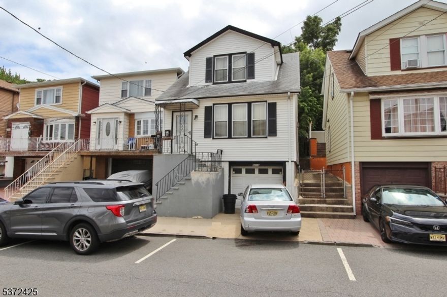 BOM As of 4-08-26-"AS IS" sale- Nestled in North Bergen with a convenient location near major bus lines and light rail access, this home offers both practicality and potential. The first level welcomes you with a flowing layout that includes a spacious living room, formal dining room, and kitchen. Upstairs, you'll find three well-proportioned bedrooms and a full bathroom. The basement level adds bonus flexibility with a utility room, laundry area, and direct access to the attached garage. Off-street parking is a true asset here, with both a driveway and garage included. Sitting on a deep 25x100 lot in an R1 zone, this property presents future development possibilities   including potential for a two-family home. The extended backyard provides ample room for outdoor use or future expansion. This property is being sold strictly  "AS IS"- seller will not do work or offer any credits. Buyer responsible for all municipal certificates and interior content removal. This is a short sale and contract is subject to third party approval.