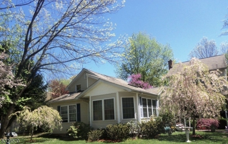 Uniquely layed out large custom home on over half acre level lot with covered Mahogany front porch. A larger  20 X 20 three season room looking over semi-private backyard with swimming pool.  Two primary suites and plenty of parking too!  Home is close to major transportation.