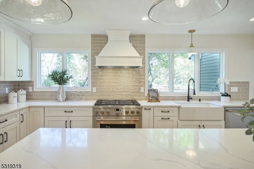 Welcomed to Florham Park's newest 2024 renovated dream home! This stunning 5-bed 4-bath meticulously designed home boasts over 2,750 sqft in the highly sought-after Florham Park community. Step inside to find a magnificent eat-in kitchen w. an expansive center island, breakfast bar, quartz counters & tile backsplash. Top-of-the-line GE Cafe Series appliances enhance this space, while soft-close white shaker cabinets add a touch of elegance. The open layout connects the kitchen, family & formal dining creating a perfect flow for entertaining. The cozy family room w. high ceilings is highlighted by a brick face wood-burning fireplace w. built-in shelving. Sliding doors from the family room lead you to a beautiful patio overlooking nearly 1/2 acre spacious & serene backyard. A 1st floor full bed w. full bath is convenient for generational living. The bright 1st floor office is multi-purpose and can be used as a formal living room. Upstairs, the luxurious master suite features a WIC & ensuite bath w. soaking tub, double vanity & large shower. 3 additional large guest bedrooms on the 2nd floor offer plenty of space. The finished basement w. full bath, rec room & laundry provides additional entertaining & storage space. Outside, the elegant white brick exterior & beautiful front porch exude curb appeal. Located minutes from downtown Florham Park & Madison w. easy access to major highways. A combination of luxury, comfort & prime location, don?t miss your chance to call this home!