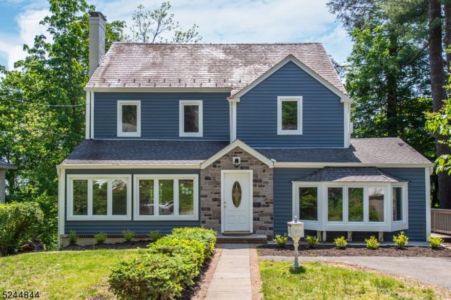 Fantastic colonial with character in one of the most desirable areas of Morristown!  Seconds to the green and all it has to offer - shopping, dining, theater, NJ Transit Train...This home has recent renovations including windows, siding, baths, newer stove and refrigerator and brand new dishwasher.  The first floor is open and airy, light and bright.  Living Room/Dining Room area has wood burning fireplace and hardwood flooring. Comfortable step-down family room, kitchen with sliders to 2 tiered freshly painted entertainment sized deck, sunroom/office, powder room and 3 season porch complete the first floor.  Second floor offers 3 generous sized bedrooms with hardwood flooring and two renovated bathrooms.  4th bedroom in Walk-out basement to deck and gorgeous huge paver patio.