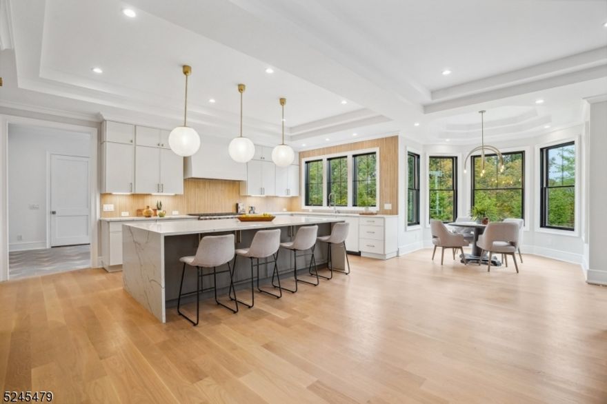 Designed by award winning architect, Thomas Baio of Short Hills, and with interior design by the acclaimed Karen Wolf of K+Co Living, this stunning new construction home in Short Hills checks all of the boxes!  Welcome to a bright and airy entrance foyer with soaring ceilings which immediately immerse you into your suburban escape. Featuring a grand oversized floor plan and a Superior Custom Kitchen with expansive island, walk in pantry, wet bar, Sub Zero & Wolf appliances, and breakfast nook to fulfill all of your inner chef's desires. Embellishments throughout including intimate and custom millwork and tile, with custom ceiling / wall features, and white oak flooring throughout. First floor is home to a formal dining room, living room, and office. The kitchen opens to the family room and patio. 1st floor in-law suite, pwdr rm and mudroom with 3 car garage entrance complete this level. The 2nd floor boasts 5 generous bedrooms, ALL EN-SUITE, with a Remarkable PRIMARY SUITE with all the bells and whistles incl custom vanity, walk out balcony, and fabulous walk-in-closet, loft area and laundry room complete this level. The basement features an enormous recreation room, leisure space and bedroom with full bath. Exterior patio with level yard and extensive privacy landscaping to embrace all outdoor enjoyment. Millburn's TOP Schools, Coveted Deerfield Elementary, Parks/Recreation, Thriving Downtown, Easy NYC Commute, Access to major highways, EWR Airport under 20 minutes and MORE