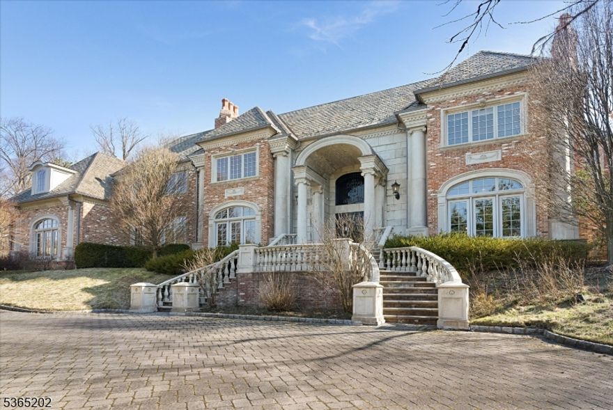 Minutes to Manhattan, this Alpine estate on a private cul-de-sac street on 2.35 AC. Timeless elegance and unparalleled luxury. Quality crafted, thisgated masterpiece boasts a stately slate roof, a sweeping circular driveway, and an opulent indoor pool all creating an ambiance of sheer refinement. Agrand two-story entrance foyer w/ marble detailing. Main level has a mahogany wood library featuring a coffered ceiling and Fpl, a regal formal diningroom with its own fpl and butler's pantry, and a sprawling great room w/ fpl, custom built-ins and Fr. doors to inside and outdoors. A professionallydesigned kitchen, complete with cozy breakfast and sitting areas, sits at the center of the home, w/ Fr. doors to private patio. An en suite guestbedroom, a spa-like pool area and 1/2 bath complete the main level. Second level has two luxurious primary suites and 3 additional bedrooms. Lowerlevel has outdoor access, home theater, bar, great room. Elevator. Much more!