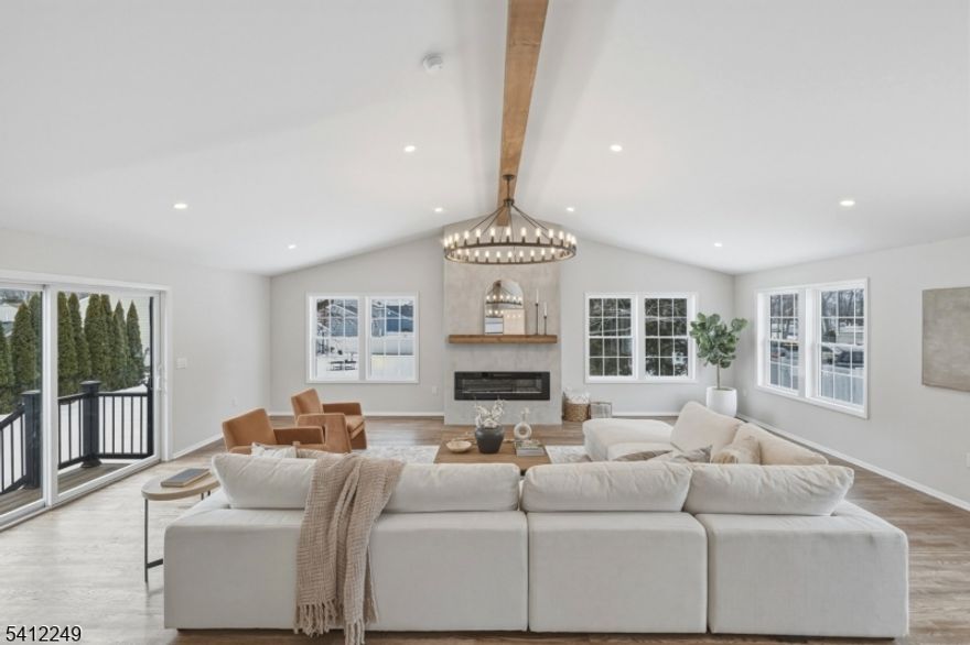 Now complete as of February 2026 with the addition of a spacious Family Room featuring high beamed ceilings, a cozy fireplace, and a stylish dry bar perfect for entertaining or relaxing in comfort. This stunning 4-bedroom, 3-bath fully renovated home offers modern comfort and versatile living space throughout. The spacious open floor plan is enhanced by beautiful wood floors and abundant natural light. The first floor features two generously sized bedrooms, a full bath, and a beautifully updated kitchen with quartz countertops, seamlessly flowing into the living and dining areas ideal for everyday living and hosting guests. Upstairs, you'll find two additional bedrooms, including a luxurious primary suite complete with an ensuite bath and walk-in closet, plus an additional hallway bath for added convenience. The partially finished basement offers endless possibilities whether you envision a home office, gym, media room, or additional living space. It also provides direct access to the oversized one-car garage, which includes convenient access to the backyard. Step outside to enjoy the elegant paver patio, perfect for outdoor entertaining or quiet evenings at home. Ideally located just moments from parks, schools, shopping, and public transportation, this move-in-ready home offers thoughtful updates in the highly sought-after town of East Hanover. Don't miss your opportunity to enjoy everything this exceptional property has to offer!