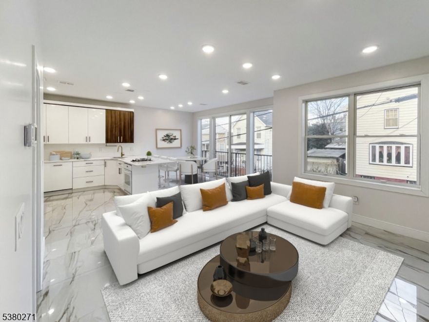 PREPARED TO BE WOWED! This stunning, newly crafted 2-family home is a beautiful blend of modern convenience and elegant design. The crown jewel of this property is the rooftop deck with panoramic 360-degree views of the area. Features include high-end furnishings, flooring, and custom windows and doors. One unit offers a bright, airy layout with large windows. The main open-concept living area is on one level, featuring a spacious kitchen with top-of-the-line appliances, multiple sinks, and a convenient powder room. On the 2nd level, you'll find 5 generous bedrooms and 3 full baths. Two bedrooms include en suite baths, while the others share a hallway bath with a separate vanity. One bedroom features a private balcony with stunning views. Laundry is also on this floor. The other unit welcomes you with a bright and expansive living room that flows effortlessly into a formal dining area. Past the stairs, there's a kitchen with dual sinks and a charming breakfast nook. This level also has two bedrooms and a second half bath. Upstairs are 3 more bedrooms and 2 full baths, including one en suite with a balcony offering picturesque views. Convenient laundry is located on this floor as well. This home offers abundant storage, high-efficiency appliances, and a shared fenced backyard for outdoor enjoyment. Situated near bus lines, JFK Blvd, I-78, shops, parks, and restaurants, this property is perfect for owner-occupants or investors. Book your showing today!