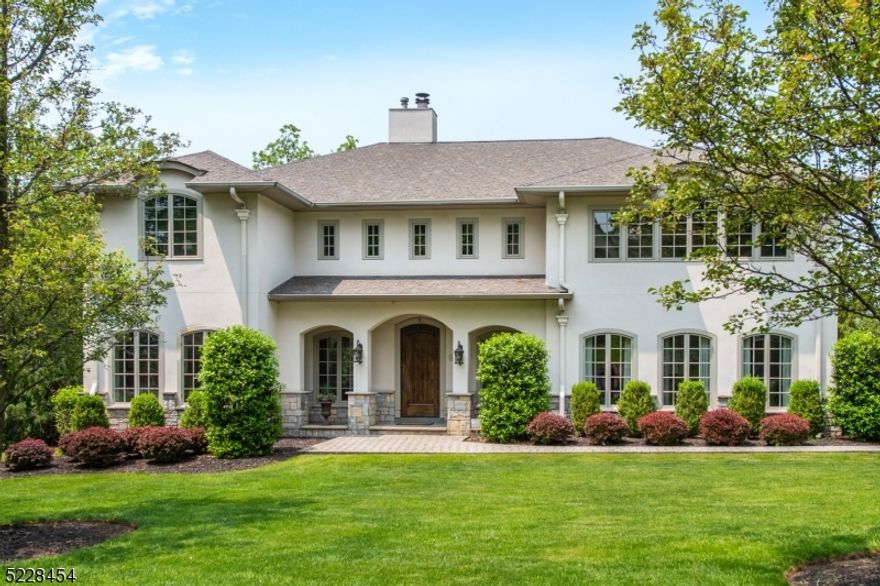 Come view this spectacular 4 bedroom, 3.1 bath center hall colonial on half acre lot, in a sought after neighborhood of North Caldwell, with top notch grammar and secondary schools. A dream come true! This unique stone and stucco home is surrounded by gorgeous grounds and impeccable landscaping. Enter into a grand 2 story marble foyer with impressive staircase, custom moldings, arch details, high ceilings, recessed lighting, hardwood floors, custom windows, and open concept flow throughout main floor. View the beautifully over-sized dining room, and formal living room with an abundance of natural light provided by the high windows. Kitchen and family room overlook expansive 1,200 square foot raised stone and paver patio. This gourmet eat-in kitchen provides all the bells and whistles. Kitchen features state of the art SS appliances, granite countertops, center island, 2 dishwashers, 6 burner oven, tiled backsplash, and wet bar with butler's pantry and custom built-ins. Upper level reveals large master bedroom suite with master bathroom that provides marble bath w/ radiant heat in floor. Three additional spacious bedrooms, laundry room and full bath finish out the top floor. A recently finished basement "nanny suite" includes, full bathroom and an additional room that can be used for a home office or bedroom.