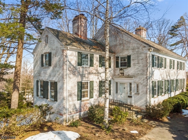 Classic brick Col on 1.1 acres w/views south to Summit/north to Morristown. Residence built in 1937 on orig foundation. Called "Ard Coille" & located on Mansion Row, this is a 6 BR/4.2 BTH/4 FP home. Amazing workmanship combining timeless architectural details w/ modern amenities of KIT &BTHS modernized in 2010. Piece de Resistance: 2021 new "Aanensen Builders" PR off lge, gracious EH. New systems 2021: converted gas furnace/service; chimney flue; 75 gal HWH; removal of oil tanks. Special feats include: rear staircase from kitchen to BR 5 & 6; staircase from basement to garage; DR w/ arched entry & carved moldings around FP; gracious LR & mahogany LIB/Office; 2nd office on FL 2; huge MBR w/ FP & dressing room.  Chatham Boro w/ its own train station, parking to NYC & a thriving downtown.  But oh those views!
