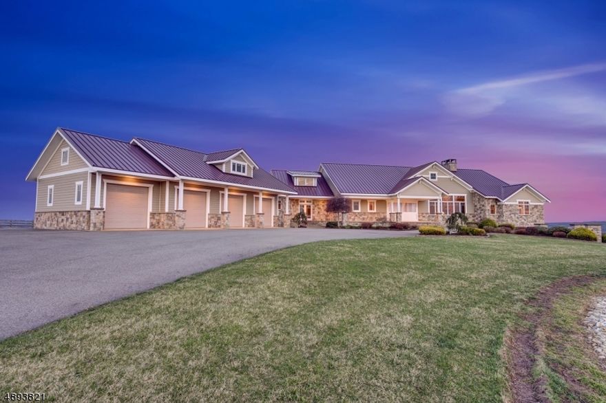 Set atop approximately 50 private acres with sweeping panoramic views of the surrounding countryside, this offering presents a rare opportunity in western New Jersey. Spanning over 8,200 square feet, the custom-built residence is thoughtfully positioned to capture its elevated setting, delivering a level of privacy, scale, and natural beauty seldom found in this market.What sets this property apart is not simply the home itself, but the irreplaceable combination of land, topography, and infrastructure. Unlike many homes whose value is concentrated solely in interior finishes, this estate offers substantial acreage, true long-range views, established equestrian amenities, and multiple Morton outbuildings providing exceptional flexibility for collectors, hobbyists, business use, or expanded recreational pursuits.Designed as a true estate residence, the home features expansive living spaces, generous garage capacity, and interiors oriented to maximize the surrounding vistas. The acreage offers both privacy and usability ideal for equestrian pursuits, outdoor recreation, or simply enjoying the exclusivity of a large landholding.This is a property whose value lies in attributes that cannot be replicated: meaningful acreage, commanding elevation, extraordinary privacy, and infrastructure already in place. Opportunities to acquire a property of this scale, setting, and versatility are increasingly rare in today's market.
