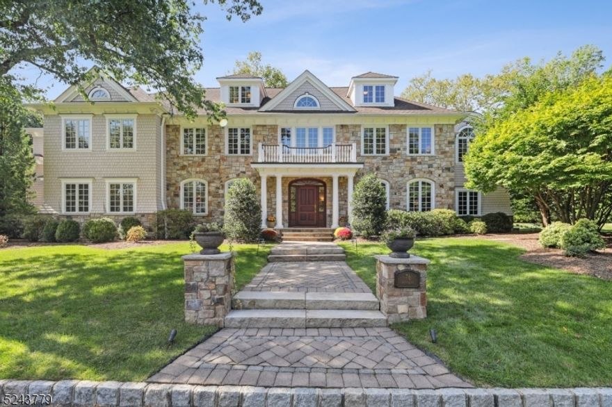 This custom-built 2007 center hall colonial on one of the most prestigious roads in Short Hills combines luxury, craftsmanship, convenient access to schools & trains, and natural Short Hills beauty. Circular driveway & hand-cut stone greet you as you enter the custom mahogany door into a majestic multistory entrance hall with 4-story staircase. Boasting 7500+ sq. ft. of above-ground finished space, this home uniquely features three luxurious oversized suites & three additional en-suite bedrooms. Primary suite features vaulted ceilings, balcony, spa-like bath with heated floors, 2 large WIC & office. A grand 2-story library with built-ins & spiral staircase leads to the primary suite. Additional 2nd floor suite with full bath, sitting room & oversized terrace. 3rd floor suite with media room, bedroom, office/art studio & full bath. 2nd floor includes 2 more en-suite bedrooms & laundry. 1st floor guest suite with heated bath floors. Stunning eat-in chef's kitchen with SubZero, Wolf, Miele, walk-in pantry, opens to incredible family room with gas fireplace & coffered 10' ceilings. French doors lead to park-like flat rear yard with patio, whole-home Bose system & ample room for pool. Private & expansive side yard allows for extra entertaining space/sports. Separate rear drive opens to 3-car heated garage with 12' ceilings allowing 6 cars with lifts. 3000+ sq. ft. partially finished basement with 10' ceilings, rough-in for full bath, and egress for bedroom. Built-in 22KW generator