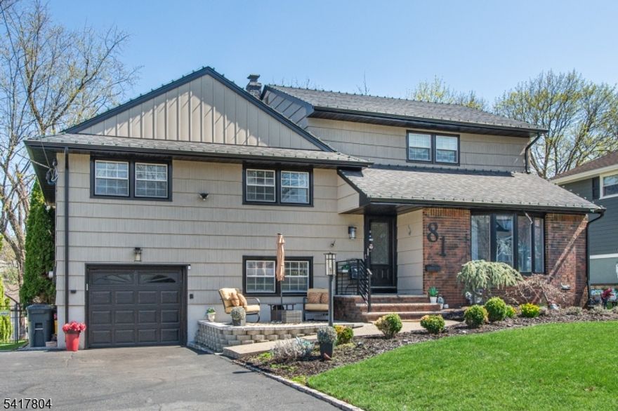 Step into refined comfort in this beautifully expanded, custom split-level home, quietly set on a tranquil street. Offering 4 bedrooms and 2.1 baths, the home showcases stunning hardwood floors throughout its spacious open floor plan, gourmet kitchen ft. a Wolf Range and Silestone Countertops  ideal for effortless entertaining or relaxing at home. Outside, enjoy a serene, park-like property with an underground sprinkler system and a gas line hookup for your outdoor grill. All just a short walk to the express bus to NYC.