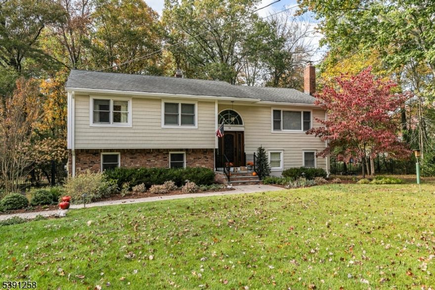 Beautifully updated 4-bedroom bilevel on .94-acres on a quiet cul-de-sac. The front property features new landscaping and lighting while the backyard is fully enclosed by deer-proof fencing with 2 gates in a peaceful wooded setting. Inside, the living room is anchored by a wood-burning fireplace and is open to the formal dining room. The brand-new kitchen is designed with high-end stainless steel appliances, center island with built-in microwave and pull-out shelves, slow-close custom cabinetry, custom tile backsplash, and expansive marble countertops providing plenty of prep space. An adjacent breakfast room adds everyday convenience. The family room impresses with high ceilings and wall of windows with elevated views of the wooded backyard, The large primary suite has a luxurious new master bath complete with a laundry chute and an enormous walk-in closet. Two additional bedrooms share a fully updated hall bathroom. On the ground level, you'll find a rec room with doors to the backyard patio, den with built-in custom cabinetry, bedroom, full bath, and laundry room. Some other updates include new front door with pocket screen, 1500 square ft addition in 2005, new gutters & gutter guards, new attic door, and EV plugin charger. Located in a top-rated New Jersey school district, this home is just minutes from transportation, restaurants, and shopping, making it an ideal blend of modern upgrades, thoughtful details, and timeless appeal in one of the most desirable neighborhoods.