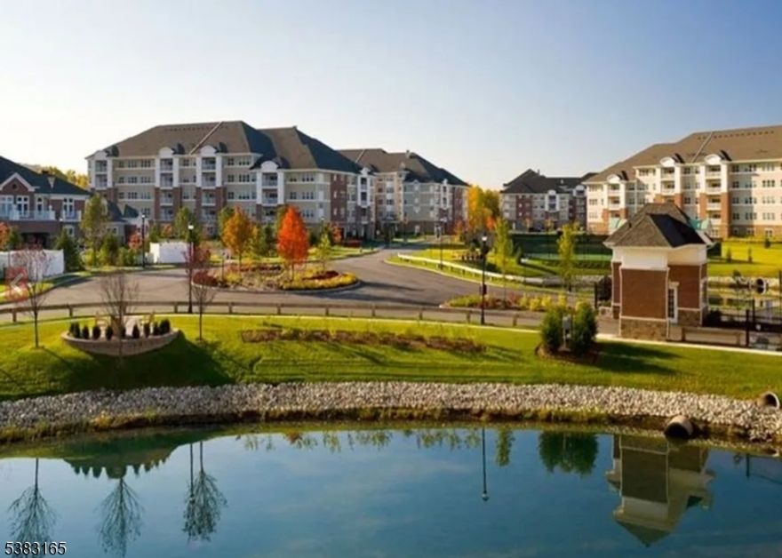 Immaculate, move-in-ready TOP FLOOR unit in building 7 is conveniently located NEXT TO THE CLUB HOUSE of this scenic community.  This 1768 SF Colfax model, a Del Webb 55+ Active Adult Community has beautiful upgrades throughout.  Enter into this meticulously maintained unit and immerse yourself in the large, sun filled open living space.  The foyer leads into a bright living room & dining room next to a den separated by beautiful French doors. LR, DR, and den floors are hardwood, the 2 BDRS carpet. The modern EIK has tile floor, decorative tile backsplash, wood cabinets, a pantry, & white appliance.  Off the kitchen is a storage/laundry room with stackable washer and dryer.  There are ceiling fans, and decorative moldings throughout and plenty of large closets with CUSTOM BUILT ORGANIZERS & plenty storage space.  The 2 Baths have CERAMIC TILE TUBS.  Enjoy beautiful views from the balcony just off LR. This unit comes with 1 under the building deeded parking spot. Wanaque Reserve offers wonderful water features, views of the Ramapo Mountains, close to walking trails, close to shops and major highways. The complex was completely renovated in 2022.  The 20,000 SF clubhouse has a large open lounge with fireplace, cafe , ballroom, movie theater, exercise room, sauna, indoor and outdoor pool, billiards room, arts & crafts room and more than 40 clubs & activities including pickleball, tennis, Mah Jong, canasta, poker, travel, & so much more. This community is a 24/7 gated community