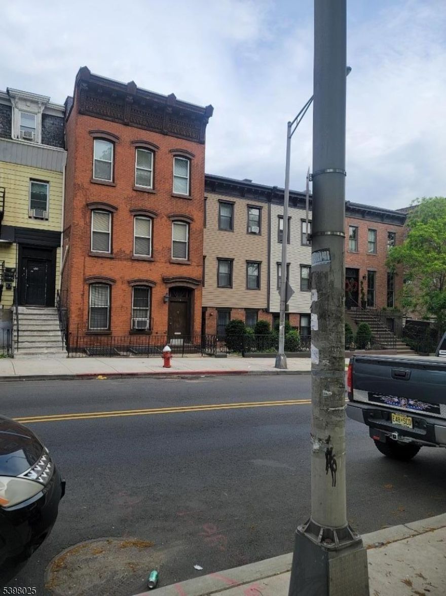 Enjoy Park views from this historic Bergen Hill 1880's Federal style brick row home. This 20 foot wide, two family home features original detail, including sweeping banister, parquet floors, and wood and plaster moldings. Large rooms with high ceilings lend to spectacular renovation potential. Owner currently resides in the lower two floor duplex with a one bedroom rental on the top floor. This could easily be converted to a fantastic single-family residence. This home has a large private yard and a full basement, home comes with brand new furnance as well.