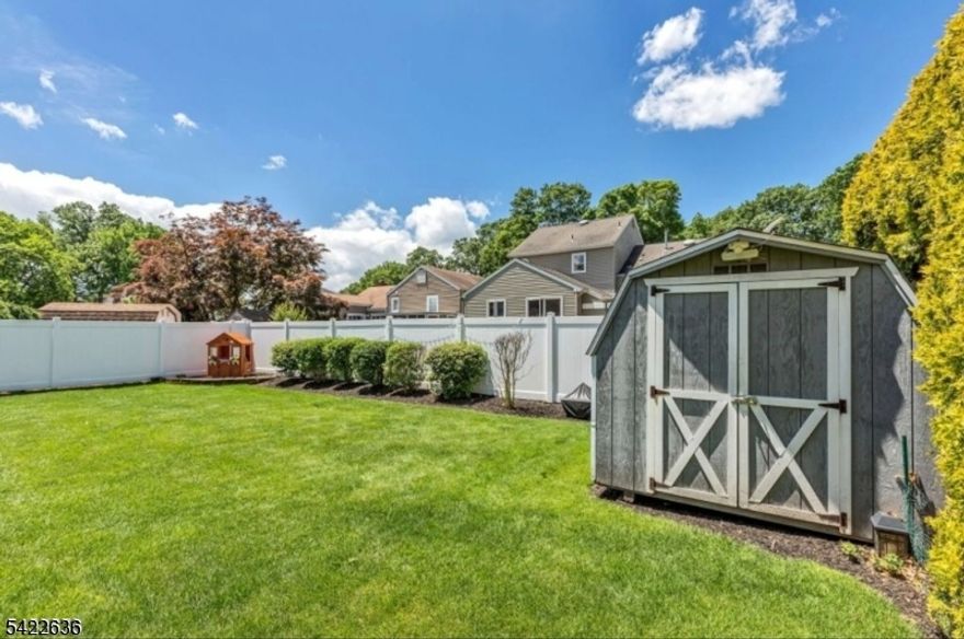 This beautifully updated 3 BR 2 full bath split boasts an open floor plan and tasteful design throughout. The main level offers a light bright living room with a cozy fireplace that leads to a gorgeous open kitchen with a large center island, ample cabinetry, stainless steel appliances, and granite countertops. There is a separate dining area. that provides ample entertaining space as well. The ground level offers a flex space den/office/guest room, a convenient mudroom space, and an entrance to the attached garage. The wonderful finished basement offers a second full bath, laundry room, and family room that is perfect for hanging out. The second level includes the primary bedroom and two additional nicely sized bedrooms, and the main bath. The entire home has been beautifully updated and maintained. Enjoy the spacious deck that leads to the patio... perfect for BBQs with friends! You will love the fully fenced yard with privacy hedges and convenient storage shed. This sweet home is conveniently located within close proximity to highly rated schools, parks, NYC transportation and all that Downtown Cranford has to offer.  Second refrigerator in garage will remain.. this house is not in flood zone.
