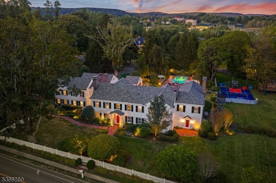 Step into a world of timeless grace with this exquisite Colonial Revival - a rare blend of historic character and modern design. Nestled on 2.2 acres within a quiet, tree-lined neighborhood in Mendham Borough, this landmark property is just a short stroll from the heart of downtown. Originally built in 1804 as a farmhouse, "Windymere" underwent a series of additions in 1910 and ultimately earned the  ?Award of Excellence? for historical renovation in 1994. One of the finest and most admired in town, this award-winning country property has most recently been extensively renovated from 2021 to 2025 and features gorgeous, designer living and entertaining spaces. Noteable elements include five bedrooms with ensuite baths, designer wall coverings and lighting, 6 gas fireplaces, a gorgeous primary suite featuring a custom walk-in closet and bath, an au-pair/guest suite, in-ground pool, hot tub, sports court, stone-walled courtyard with English gardens, level, open lawn, fully fenced perimeter, and three car attached garage. Premier location - walking distance to town shopping and dining within the Mendhams and minutes to Morristown?s train line for easy access to Manhattan. A truly rare offering.