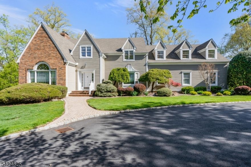 Set on a quiet cul-de-sac, this magnificent sundrenched south-facing colonial with a circular driveway makes an unforgettable first impression. A grand entry w/ gleaming marble floors & a sweeping staircase welcomes you, flanked by elegant formal living & dining rooms. The living room is a showpiece w/ its tray ceiling & stunning inlaid hardwood floors. The heart of the home is the updated chef's kitchen featuring a custom-built buffet server, high-end commercial-grade appliances, granite countertops, & a center island with a sink. The adjoining family room is warm & inviting, highlighted by a dramatic stone wood-burning fireplace & seamless access to the patio perfect for indoor-outdoor living. A private first-floor bedroom/office, laundry room, & powder room with direct access to the three-car garage complete this level. Upstairs, dual staircases offer both convenience and privacy, leading to a private ensuite bedroom, 4 additional spacious bedrooms, and a charming reading loft with custom built-ins. The primary suite is a true retreat, entered through double doors. It offers hardwood floors, a wood-burning fireplace, 2 outfitted closets, and a spa-like bath w/ a double-sink vanity, soaking tub, vaulted ceilings, skylight, and glass-enclosed shower. The expansive lower level is ready to be transformed into a home theater, gym, or recreation space. Step outside to a secluded oasis, where a beautifully paver patio and lower-level terrace are surrounded by lush landscaping.