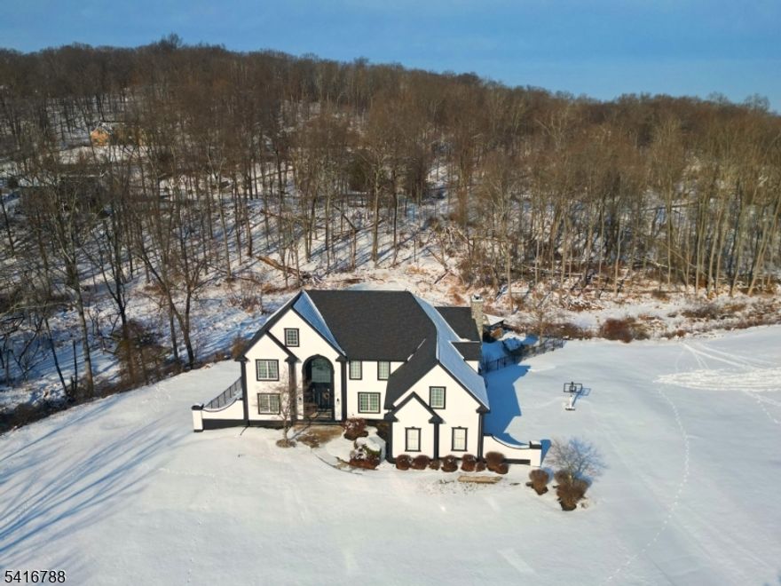 Completely renovated home delivers a fresh contemporary style to a classic 1998 colonial. This home is meticulously updated inside and out. Enter into a soaring 2 story foyer with a Swarkovski crystal chandelier. Continue onto the main level with an open floor plan that features an office or library (currently used as 5th bedroom), a completely updated kitchen with commercial grade appliances that opens onto an upper deck?perfect for warm-weather dining. The two-story family room features a natural gas fireplace and sliders to a bright 3-season room. Upstairs is a quiet sitting/reading loft area that overlooks the family room. Retreat to the Primary Suite with its own sitting area, two walk-in closets and a huge bathroom with soaking tub. Additionally there are three oversized bedrooms with generous closets. The fully finished basement adds approximately an additional 1,200 Sq. Ft. of entertainment space with a walkout to the in-ground pool, covered patio, and outdoor fireplace and overflow bedroom. Set on 2.84 acres of open, level property, with amazing sunsets this home offers ultimate luxury.