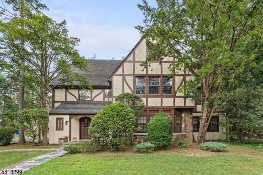 After more than 40 years, this distinguished Tudor-style residence in the highly sought-after Seven Oaks Park section of Orange is ready for its next chapter. Offering a rare combination of scale, character and location, this home stands out as a compelling opportunity in today's market. Showcasing timeless architecture and gracious proportions, it offers over 5,500 sq ft of living space on .45 level acres, an increasingly rare find. A dramatic two story foyer sets the tone as you welcome guests to your home. The story continues and leads to elegant living spaces, a formal living room with a WB fireplace, banquet-sized dining room with French doors, dedicated office, and family room with soaring cathedral ceilings and access to a finished basement with full bath. It features 6BR/5.1BA, including a private 2BR guest suite. Upstairs, each bedroom has en suite baths, including a Jack-and-Jill layout. The primary suite offers a private bath with a cast-iron soaking tub a perfect place to unwind and recharge. Original details like cast-iron tubs and sinks, classic tile, and vintage hardware blend with updates including a renovated powder room, roof, gutters, furnace, hot water heater, and newly paved driveway. An additional unfinished basement spans the full footprint. Two-car attached garage .Ideally located near transit, dining, shopping, parks, and cultural attractions, this is a rare chance to own a home of scale and history.