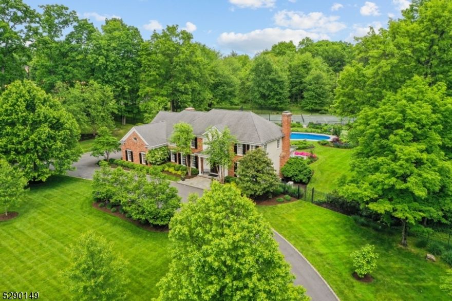 Located in the historic Washington Valley section of the Township, this 3-acre property is a must-see private oasis. This custom home has an elegance; high ceilings, elaborate moldings, columns, archways, plantation shutters, and floor-to-ceiling windows. Grand entry with solid custom mahogany door sets the tone for quality workmanship. Top-of-the-line kitchen with granite center island, breakfast bar, stainless SubZero refrigerator, contrasting custom cabinetry, dishwasher drawers, and walls of windows overlooking the lovely resort-like property. Scattered bursts of color from stunning flowers and plantings, bluestone walkways and patios, outdoor built-in Viking grill, Gunite pool with a liner, hot tub, Har-Tru tennis court with Hydro-court irrigation system, Rain Bird watering system. First floor library with fireplace and double French doors leading to a gracious covered porch featuring bluestone flooring, beaded ceiling and ceiling fan with a view of paradise. Family room with 12-foot coffered ceiling, spectacular built-in cabinetry and moldings, fireplace, Pella floor-to-ceiling windows with remote shades. Luxurious primary suite with high ceilings, wood floors, sitting room with fireplace, extraordinary private bath, dressing room, cedar closet and huge walk-in California closet. Private office with custom built-ins, custom laundry, three additional bedrooms and well-appointed bathroom. Control 4 Stereo System, radiant heated garages This home is simply indescribable!