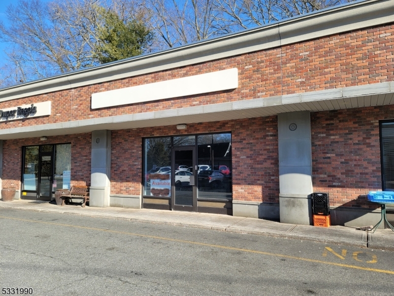 A window storefront with 800 sq ft in a strip mall with parking includes a half bath and a small office cubicle. Two restaurants, a bagel shop, and a nail salon are also in the strip mall. The restaurant will attract potential customers.