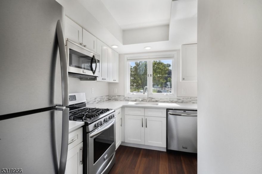 Welcome to your new home! This beautifully renovated multi-level townhouse blends modern convenience with cozy charm. The multi floor unit, updated in 2019, boasts a sleek kitchen equipped with stainless steel appliances, perfect for cooking enthusiasts. The open living space features stylish and durable luxury vinyl plank flooring on main floor. Natural light streams in through skylights and a sliding door that leads to a private deck ideal for relaxation. The spacious primary suite offers comfort with carpeting and a renovated bathroom that adds a touch of luxury. Freshly painted throughout, this home feels bright and inviting. Conveniently located near Routes 10, 46, 80, and 287, it offers modern living with easy access to everything you need. Nothing to do but unpack and enjoy!