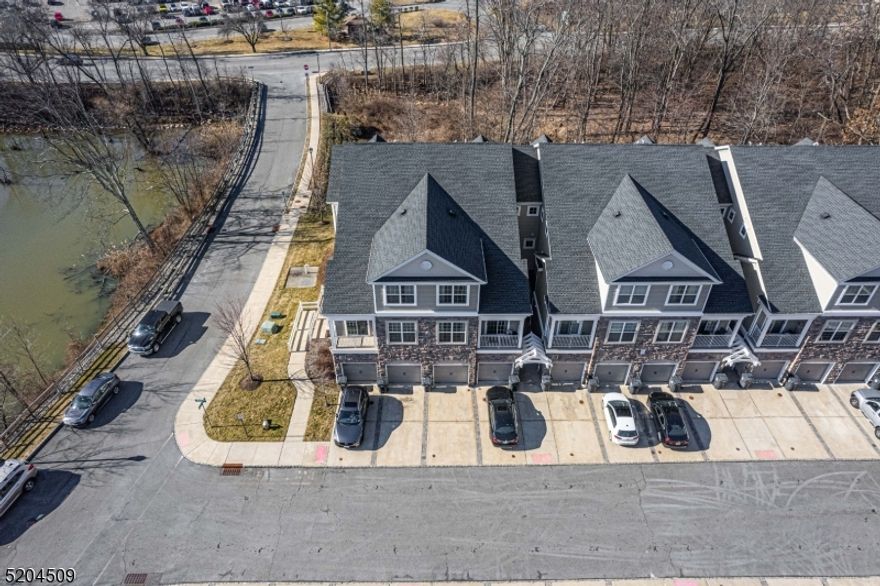 Located amid natural beauty for which the sought after WaterView community lives up to its name. This spectacular end unit, multi level living offers residents the rare opportunity of a water view & outdoor space. Conveniently located in Cedar Knolls/Hanover Twp which is just 1 mile from NYC Direct Train Station, buses & easy access to highways. Open & bright, beautiful engineered wood flooring in the living / dining. Both the living room and dining room have access, from sliding glass doors to a private deck with alluring water views. Updated kitchen with SS appliances, granite countertops, breakfast bar & 42  cabinets! Convenient laundry/mudroom off the one car garage. Upstairs, a master bedroom with full bath, walk-in closet and private balcony overlooking the woods. Second generous sized bedroom & full bath with tub shower. Pristine condition. Less than 10 years young! The attached 1-car garage has a storage room area and dedicated driveway. Thermal windows and doors. HOA only $265 a month! Wonderful community with curbs and sidewalks. Hanover Township has a township pool, community center, before/after school programs and so much more! Low property taxes & excellent schools.