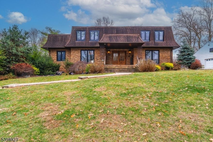 Beautifully updated in 2023 and set on a cul-de-sac, this expansive Colonial blends modern upgrades with striking architectural character complete with a resort-style backyard and a rare three-car garage. The home welcomes you with a stately mansard-style façade, double-door entry, and a wide front lawn framed by mature landscaping.Inside, the main level offers exceptional living and entertaining space. The newly renovated kitchen steals the show with a large center island, warm gold accents, custom cabinetry, and an open flow into the family room. The family room features built-ins, a wood-burning fireplace, and sliders that open directly to the pool area. A formal dining room with coffered ceilings, a spacious living room, a dedicated office, and a full bathroom complete the level.The second floor includes a generous primary suite with an oversized en suite bathroom featuring a soaking tub, mirrored vanity surround, and a bidet. Three additional bedrooms and a common bathroom provide flexibility for all lifestyles.The finished basement is a true extension of the home, offering a large family room, play or recreation space, a full bathroom, laundry, electric fireplace, and a full Florida kitchen.Outdoors, enjoy your own private getaway: an in-ground pool with safety fencing, a raised entertaining terrace, and plenty of yard space. The three-car garage and expanded driveway offer exceptional parking and storage.