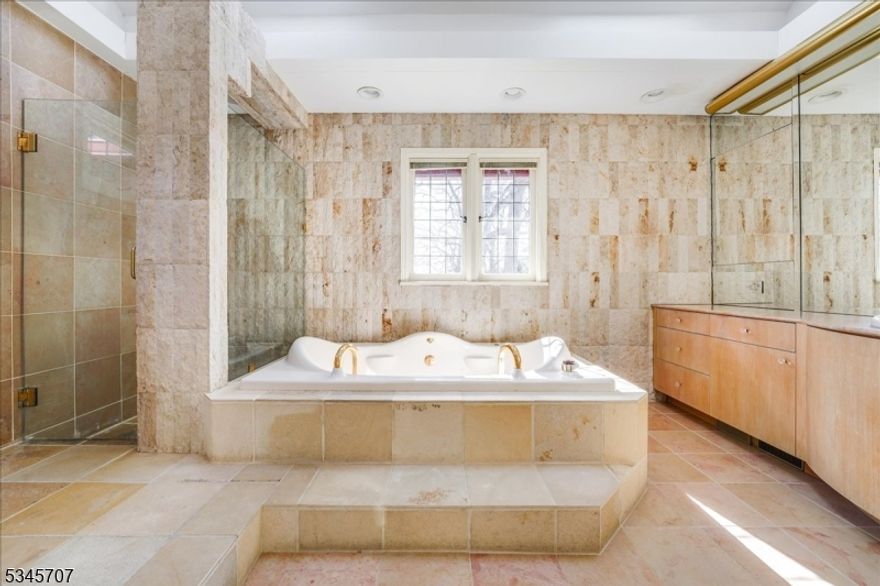 circa 1927 brick & stone home resting on .85+ acres of peaceful land. Stately tranquil property nestled in the heart of Old Short Hills. Set back from Grosvenor road offering private living on a grand scale. This property is perfect for secluded living or grand celebrations. EXT:large drive, w/add parking area. Pvt. yard with pond, waterfall stone terrace. Rolling lawn-old growth trees INT: 13 spacious rooms,3lge baths-2 water closets. 6 BRS, entrance hall w curved staircase. Views of conservatory, dr & lr from entrance hall. DR/LR w/wooden and pvt entrance to 2 private rooms & bath. basement 2 car garage, garden room w/ basement access. lge laundry hobby room, gaming room& closets AIR/RAIL/SCHOOLS Nursery, grammar, middle and high schools.Millburn train station is 1.5mi/Short Hills train is 2mi.Newark airport 12 mi. Sale of property as is. We ask all offers be submitted by friday May 2nd, 2025 6:00pm est.