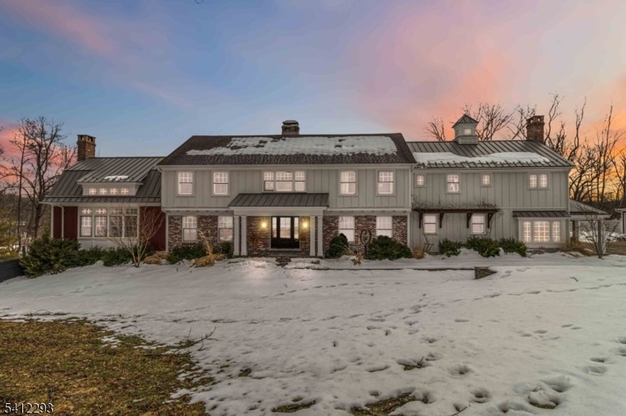 Exceptional, Fully Renovated Colonial in Serene Park-Like Setting. This spectacular 4 Bedroom Custom Colonial was completely renovated and expanded, and meticulously appointed with luxurious custom finishes including hand-hewn beams, reclaimed wide-plank hickory wood flooring, and beautiful stone work. A semi-open floor plan features generously sized rooms bathed in warm natural light, high ceilings and top-of-the-line appliances. The hub of the home is a show-stopping kitchen with all the bells and whistles: custom cabinetry, two large islands, hickory baker's table, dining area overlooking the pool and yard, separate walk-in pantry, sitting area with fireplace, full-size SubZero refrigerator and freezer, and SO MUCH MORE! The second level features a private primary suite with an office, 2 walk-in closets and stunning marble primary bath with radiant heat. Walk-out lower level with second kitchen, full bath, rec room, gym and more. Situated on just over 3 acres and backing up to preserved park land, this home offers a restful retreat with great outdoor space: expansive stone patios, heated salt-water pool and hot tub with waterfall, outdoor gas BBQ, fire pit, gardens and great views. See feature sheet for additional details. A true show-stopper!