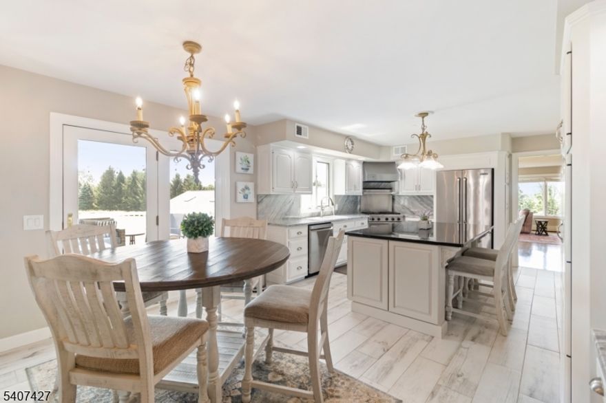 Welcome to 11 Beavers Road, a brick-front Colonial set on 6.47 acres of flat, fully usable land in sought-after Tewksbury Township, offering privacy, flexibility, and a lifestyle rarely found. A circular driveway and three-car garage create an impressive arrival, leading to a grand two-story foyer with marble flooring, chandelier, and dual staircases that establish an elegant yet inviting flow. The gourmet kitchen features stainless steel appliances, a Viking range, and a spacious center island ideal for everyday living and entertaining. A main-level bedroom with full bath offers flexible use for guests or a home office. The finished walkout basement expands the living space and opens directly to one of four outdoor entertaining areas, creating seamless indoor-outdoor living. A true standout is the approx. 5,000 sq ft outbuilding, featuring a year-round indoor inground pool and expansive open space ideal for storage, a gym, workshop, recreational use, car collection, or equestrian use. Did you know? This property was once known locally as "Field of Dreams,  complete with a full baseball field in the backyard highlighting the rare scale and openness of the land. With a brand-new septic system, exceptional acreage, and unmatched versatility inside and out, this special property offers the freedom to design a lifestyle all your own just minutes from shopping, dining, and commuter routes, yet worlds away from the ordinary.