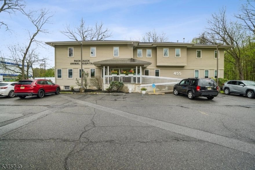 455 Newark Pompton Turnpike presents a unique mixed-use opportunity in the heart of Wayne's highly trafficked retail and service corridor. This highly visible property consists of two units plus additional walk-in basement storage and offers approximately 4,780 SF excluding the basement. The first-floor commercial unit is anchored by the long-established Packanack Animal Hospital, a trusted veterinary practice serving the community for decades. The hospital lease does not include the walk-in basement storage area, offering additional flexibility and value for an owner-user or future tenant. The second-floor unit spans approximately 2,760 SF and is currently configured as a spacious 5-bedroom, 3.5-bath residence featuring a gourmet kitchen, private entrance, chair lift access, and access to a large shared backyard. The layout lends itself well to a live/work setup, staff housing, professional offices, or a variety of other permitted uses. Additional highlights include excellent visibility on Newark Pompton Turnpike, ample on-site parking with potential for expansion, large shared outdoor space, and convenient access to Route 23, Route 46, and Interstate 80. Flexible zoning supports a wide range of commercial and mixed-use possibilities.