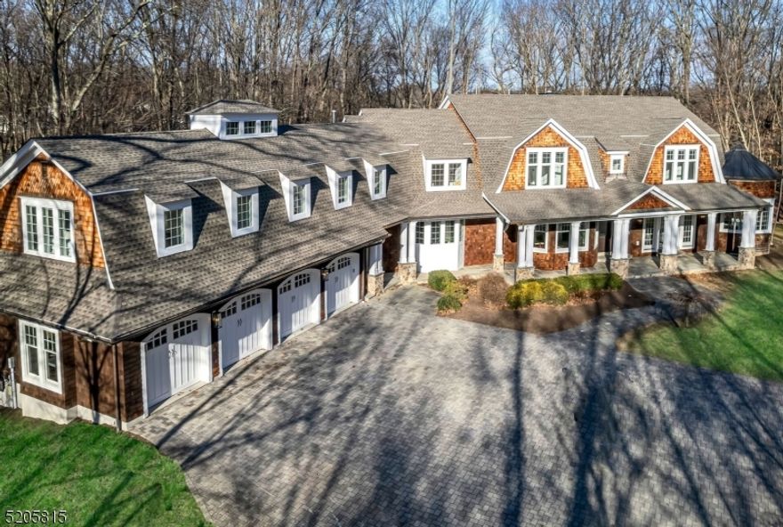 The lifestyle you've been waiting for! This custom built Hamptons style home redefines luxury from end to end. Boasting 4.6 acre of exceptional privacy, the meandering driveway unveils approx 12,000 sf (3 floors) of on-point design and exquisite detail. 6 bed, 6.2 bath, phenomenal millwork, walls of windows framing verdant views. Experience a feeling of comfortability the moment you enter. Each room is positioned for easy living and entertaining. The Great Room with coffered ceiling and wood burning fireplace, the spacious gourmet kitchen beaming with natural light and positioned perfectly next to a huge mudroom and pantry. Multiple doors lead to bluestone covered porches around the home that overlook the estate like property. Also enjoy a commanding office and private guest suite. Upstairs find a LUXE Primary/Spa Bath, 3 additional Bedrooms, a homework room and a Guest WING providing ultimate comfort for all! Finished Lower Level has 12' ceilings and amazing spaces. Great location, minutes to downtown centers, 2 miles to train!