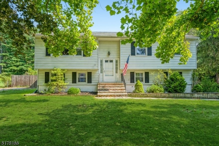 A spacious design on an oversized lot in Warren County!  Welcome home to this move-in ready Bi-Level with four bedrooms, two full bathrooms, an attached two-car garage, and an in-ground swimming pool. Built on a corner lot on a quiet, tree-lined street in a rural setting, this home is near a Walmart Super Center, a State Game Farm, M&M Mars Chocolate Factory, Centenary University, and two brewery tasting rooms. A manicured front lawn and walkway lead you inside to the light and bright interior with hardwood floors and an open floor plan. The large, sunny living room flows to the open dining area and a spacious eat-in kitchen. The kitchen features warm oak cabinets, generous counter space, stainless steel appliances, and a cozy breakfast corner. Down the hall is the primary bedroom, two additional bedrooms, and a full hall bathroom. The lower level contains a fourth bedroom, laundry room, access to the attached garage, and a full bathroom off the sun-filled family room. Double sliding glass doors bring in lots of natural light and open to a fabulous back yard including a multi-level patio with plenty of space for outdoor cooking, dining, and entertaining. Beyond the patio is a built-in fire pit, a large storage shed, and a refreshing in-ground pool that is fully fenced and surrounded by a wide pool patio. This home has it all and is ready to be enjoyed!