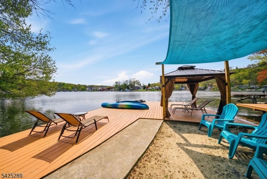 Rare & Unique!!! 3 ACRE!!! Nature Lovers LAKEFRONT Paradise! Unparalleled Privacy. With Expansive Decks, Docks ,Picnic Area, Water Views,Stone Walls & Walkways & Tranquill Stream. Amid the Green Lush Wooded lot, a Vibrant Sanctuary for Bird Watching & Enjoying local wildlife. An Entertainers Dream with Above Ground Pool, Hot Tub With Enclosure, Retractable Awning, Pergola, Outside BBQ Kitchen.Open & Covered Areas. With Approximately 217 Feet of Lakefront you can bring all the Water Toys! Boats, Kayaks, Jet Skiis & more! You have the Room here.That's just the outside! Come inside to 3 Cozy Bedrooms, 2 Full Baths. Beautifully Updated Kitchen,Wood Floors and Living Room with Wood-Burning Fireplace & Central Air. 2 car Detached Garage with attached additional covered area for additional Pavillion Vibes can be turned into an extra play space in whatever way you can Imagine. Full Clean, Dry Unfinished Basement for tons of Additional Storage! Everything you need or desire to enjoy Lake Living here at beautiful Lake Hopatcong !  Live like your on vacation all year round or use it as your private Lakefront Retreat. Whether Year Round or Weekend refuge this one will not be like most homes on the lake! come see it today.