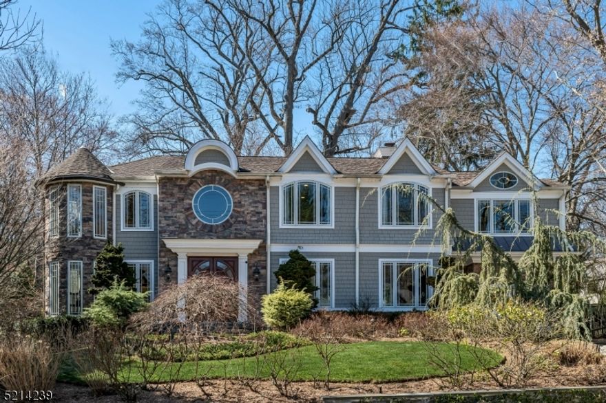 Dramatic focal points and luxurious details will make you fall for this 2007 new construction home on a tranquil half acre lot with close access to restaurants, shops, and commuter transportation. Marked by stunning light-filled Pella windows, exceptional millwork, and an open floor plan, the WOW begins in the 2-story foyer with curved staircase and onyx tile floor that opens to the living, dining, and family rooms. The contemporary kitchen boasts high end appliances, including Subzero refrigerator, 8-burner Wolf range and double ovens, and Miele dishwashers. The primary suite spans 800sf and includes a sitting room with private balcony overlooking the grounds. Another en suite and two more spacious bedrooms complete the second floor. The lower-level game room with pub area features a dramatic glass-walled wine cellar. New roof, gutters, and HVAC, plus multiple smart home technologies await the new owner. The perfect blend of elegance and comfortable everyday living!