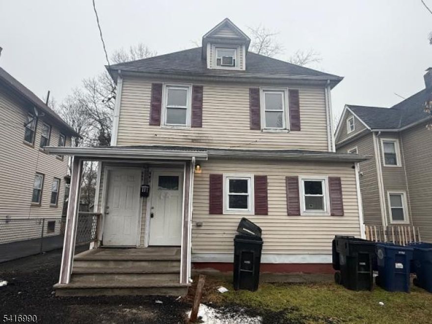 Side-by-side two-family property with separate entrances. Each unit offers living space, kitchen, bedrooms and full bath. Property also includes basement and attic areas providing additional space. Features a small front porch and driveway access. Conveniently located near local roads, shopping and public transportation. Property sold as-is, Purchaser responsible for CO.