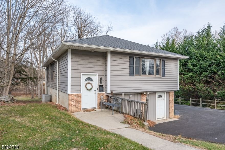 MULTIPLE OFFERS. HIGHEST AND BEST DUE 12.23 AT 5 PM. This beautifully maintained bi-level home offers natural gas heat, public water and sewer, and central air, all set on a spacious lot just over half an acre. The main level features a bright, sun-filled living room with newly installed vinyl flooring, three generously sized bedrooms, and a full bathroom. A convenient pull-down staircase provides access to a full attic for additional storage. The ground level boasts an oversized family room with a private exterior entrance, a large fourth bedroom, and abundant storage space. You'll also find a dedicated laundry area complete with washer and dryer (included), along with an additional closet tucked under the stairs. Outside, enjoy ample off-street parking with a large driveway and all-new exterior siding. Ideally located close to downtown shops, dining, and major highways, this home offers the perfect blend of comfort, functionality, and convenience.