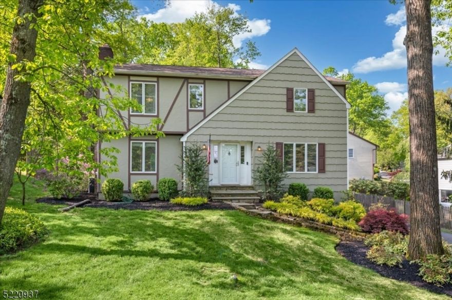 Gorgeous Updated Colonial in a Dream Location! 3 bedrooms, 2.5 baths, attached 2-car garage, and abundant natural light throughout, this beautiful home is set is close to everything including downtown shopping and dining, top rated schools, and numerous parks, as well as highways and NJ Transit trains for easy commutes. As you enter, you're greeted by a welcoming foyer that opens to a spacious formal living room with tall windows and showcasing the gleaming hardwood floors seen through much of the main level. A formal dining room with chair rail detail has direct flow into an eat-in kitchen equipped with rich wood cabinets, recessed lighting, granite counters, center island, stainless steel appliances, and a cozy breakfast nook nestled in front of windows with views of the backyard. Next is an elegant family room with a wood burning fireplace and sliding glass doors out to the large deck and fenced backyard beyond for effortless indoor-outdoor entertaining. A discreet powder room is tucked in the corner, completing this level. Upstairs you'll find 3 generously sized bedrooms with plush carpeting including an oversized primary with adjoining room that can be used as a nursery, office space, or a personal gym, as well as a full en-suite bath with tub and extra-wide vanity. Down the hall is the second full bath with wood storage vanity. The unfinished basement level houses the laundry, plus utilities, garage access, and ample space for storage.