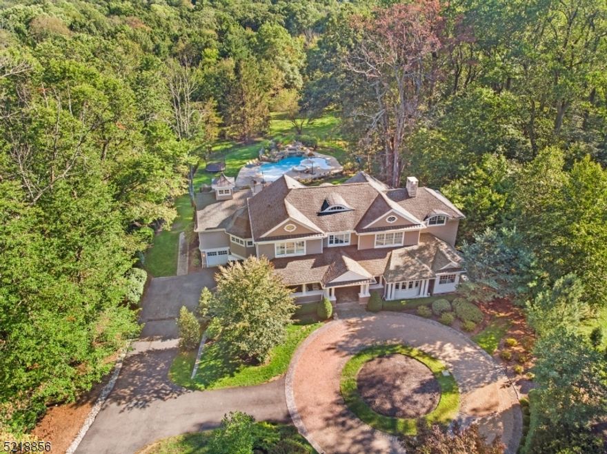 Absolutely magnificent, this unique Shingle-style home in the period design tradition of renowned architect Robert A.M.Stern was constructed in 2007 and shows like it was just completed.This gorgeous home is replete w a broad covered front porch, gabled roof lines, & classical columns-melding stylistic warmth & contemporary elegance in the most compelling of ways. 10 rooms, 5 bedrooms,5 full and 2 half baths, 2 fireplaces,& coveted 1st floor master bedroom suite. A truly, one-of-a-kind luxury home w unwavering attention to detail-this exquisite estate offers over 5,400 sq ft of living space on the upper 2 floors & bright patio level on grade w walk-out French doors to the rear-yard bluestone patio, stone fountain, & lavish gardens. Outstanding elevated composite deck with weather-defying retractable awning. 3-car  attached garage w circular drive. Absolutely jaw-dropping 35,000 gallon in-ground heated salt water pool boasts a bubbling spa,  ledge area with water jets (perfect for relaxing in shallow water), grotto with waterfall, and amazing "hidden" slide that emerges from a landscaped rock formation that must be seen to be truly appreciated.  Large outbuilding in rear yard. Breathtaking , professionally landscaped and maintained 2-acre showpiece property.