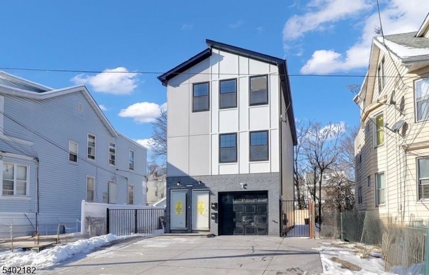 Explore the epitome of modern living in Irvington. This custom new-construction two-family residence offers a thoughtfully designed layout with quality finishes throughout. Each apartment features a functional floor plan with bright, open-concept kitchens equipped with ultra-stainless steel appliances, quartz countertops, and rich custom cabinetry. The first unit extends to the ground level, creating an exceptional duplex with flexible living space ideal for recreation, a home office, or additional living area. This level includes a bathroom, laundry, and direct access to the garage. Both the first and second floor apartments offer three spacious bedrooms and two full bathrooms. Primary bedrooms include walk-in closets and contemporary en-suite bathrooms with modern fixtures and a spa-like feel. Additional highlights include a gated patio, yard, and driveway, a one-car garage, and a driveway accommodating up to six additional vehicles. Enjoy low taxes with a 5-year tax abatement. Conveniently located near parks, shopping, dining, and NYC transportation, this home offers easy access for commuting and everyday living.