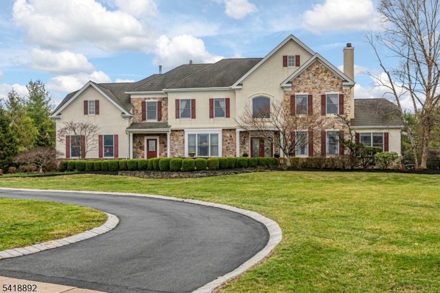 Set on more than two acres, this expansive home pairs luxury and leisure with ease. Inside, beautifully proportioned rooms include a dramatic family room with soaring windows and a wood-burning fireplace, a gracious living room with a gas fireplace, an airy conservatory, a den, and a sunlit kitchen with high-end appliances and a large island at its center. Outdoor living is equally inviting with a paver patio, outdoor kitchen, pool, spa, and fenced grounds. Upstairs, the main suite is a true sanctuary with three walk-in closets, a kitchenette, bathroom, and a home office. Two more bedrooms share a Jack-and-Jill bathroom, while the guest suite has its own bathroom. A home theater, gym, recreation room, full bath, and wine cellar create a destination all their own in the walk-out lower level.