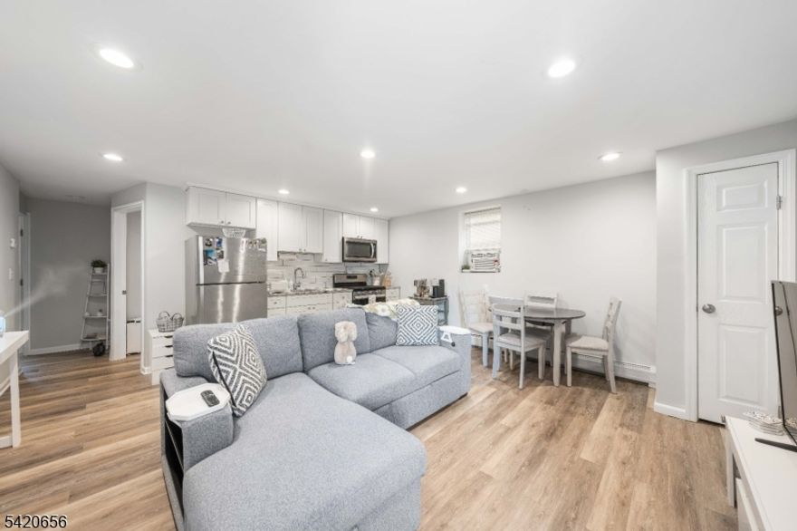 Rarely does a turnkey investment opportunity align so perfectly with high-end residential comfort. This newly renovated 2-family home, meticulously updated in 2018, offers a level of symmetry and sophistication that is hard to find in the multi-family market. Whether you're looking to live in, house hack or build a high-performing portfolio, the layout is a dream: two identical, sprawling units that both feature sun-drenched living and dining areas, spacious kitchens ample countertops, and shimmering hardwood floors. Each unit is anchored by a true primary suite with a private en-suite bathroom, plus two additional well-sized bedrooms and a stylish common bath, ensuring no one has to compromise on space or privacy. The versatility of this property extends even further with a fully finished walk-out basement. Designed with its own ground-floor entrance, this level lives like a private retreat with bonus living space, complete with a cozy family room, a guest bedroom, a convenient kitchenette, and full laundry facilities. Outside, the lifestyle remains effortless; the expansive paver patio is an entertainer's delight, framed by a secure, fully fenced backyard that offers a rare slice of suburban quiet. Positioned just a half-mile from the bustling bus routes of Morris Avenue, this home is a commuter's dream, blending city accessibility with residential tranquility.