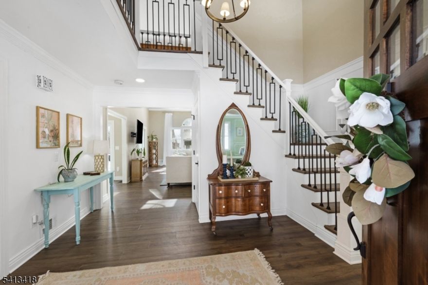 Welcome to this beautifully reimagined 4,437-square-foot Colonial, privately nestled on 4.73 picturesque acres at the end of a quiet cul-de-sac in highly sought-after Chester Township. With four bedrooms and four baths, this exceptional home offers a bright, open feel enhanced by fresh interior and exterior paint, refined modern finishes, and wide-plank LVP flooring that flows seamlessly throughout. At the heart of the home, the fully renovated chef's kitchen is both striking and functional, featuring sleek quartz countertops, premium Cafe appliances, and a layout designed for effortless entertaining and everyday living. Custom designer wallpaper elevates the dining room, while detailed millwork, elegant paneling, and stunning shadow box moldings add architectural character and timeless sophistication throughout. The primary and guest baths have been thoughtfully updated with a balance of comfort and elevated design. Newly installed interior doors, custom trim work, and recessed lighting throughout create a warm, cohesive ambiance. Brand-new garage doors complete the exterior with enhanced curb appeal. Blending classic Colonial charm with today's most desirable finishes, this turnkey estate offers the rare combination of privacy, acreage, and impeccable updates, an exceptional opportunity in one of Chester Township's most coveted settings.