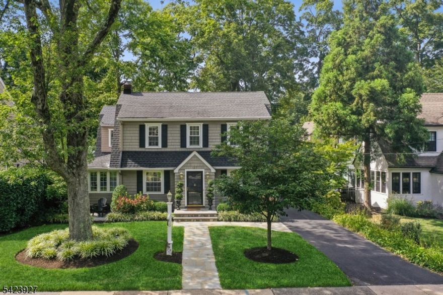 Set on a picturesque tree-lined street with sidewalks in Madison's coveted Hill Section, this exceptional 4-bedroom, 3.1-bath residence offers refined living just a few blocks from town, Midtown Direct train, top-rated schools, boutique shops and popular restaurants. Beautifully renovated, the home blends timeless elegance with sophisticated modern comfort. At its heart is a stunning chef's kitchen appointed with premium appliances, including a Viking 8-burner gas range and wine refrigerator, opening seamlessly to the sun-drenched dining area, gracious living room with fireplace and expansive family room overlooking the fully fenced private backyard. French doors lead to a bluestone patio, creating an effortless indoor-outdoor flow ideal for entertaining. A convenient mudroom, private home office and powder room complete the main level. Upstairs, the luxurious primary suite is a serene retreat featuring cathedral ceilings, dual walk-in closets and a spa-caliber bath with double vanity and oversized glass shower. Three additional bedrooms and a full bath provide generous accommodations, while the finished lower level offers a recreation room, full bath and abundant storage. Additional amenities include an electric vehicle charger, invisible dog fence and two parking spaces adjacent to the garage. Combining walk-to-town convenience with the prestige of one of Madison's most desirable neighborhoods, this is a rare offering in an unparalleled location.
