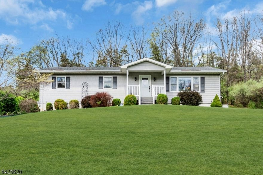 Escape from the stress of daily life and reconnect with nature without sacrificing convenience. This lovely 3-bedroom, 2-full-bath home is located on 2 acre open/wooded lot within a five-mile radius of an active town center, excellent schools, and a hospital. Additionally, the area offers plenty of hiking trails and is less than 25 miles from  Mountain Creek ski slopes and water park.. Minutes from Rt 206 and Rt. 94.  The home features hardwood floors throughout the living room, dining room, and hallway. These spaces are complemented by a ceramic-tiled kitchen equipped with stainless steel appliances. Additionally, the living room includes a pellet stove, perfect for staying warm and cozy during the winter months. This move-in-ready property also includes a full home generator, attached two car garage along with an unfinished basement, offering significant potential for customization. This home is a must-see to truly appreciate its value.